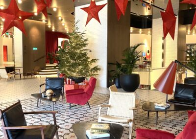 a room with red chairs and a tree